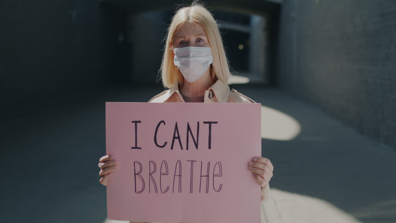 Woman holding a sign protesting social injustice