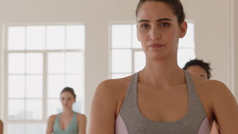 yoga class instructor teaching tree pose to beautiful group of women enjoying healthy lifestyle exercising in fitness studio meditation