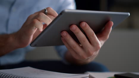 business man researching tablet analyze corporate data writing notes in office.