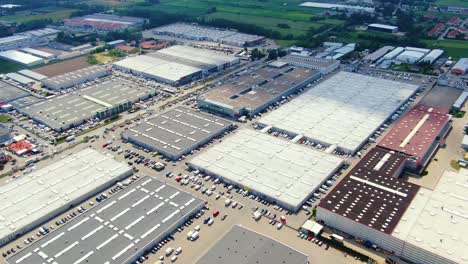 aerial footage of a large shopping centre and car parks located in the city