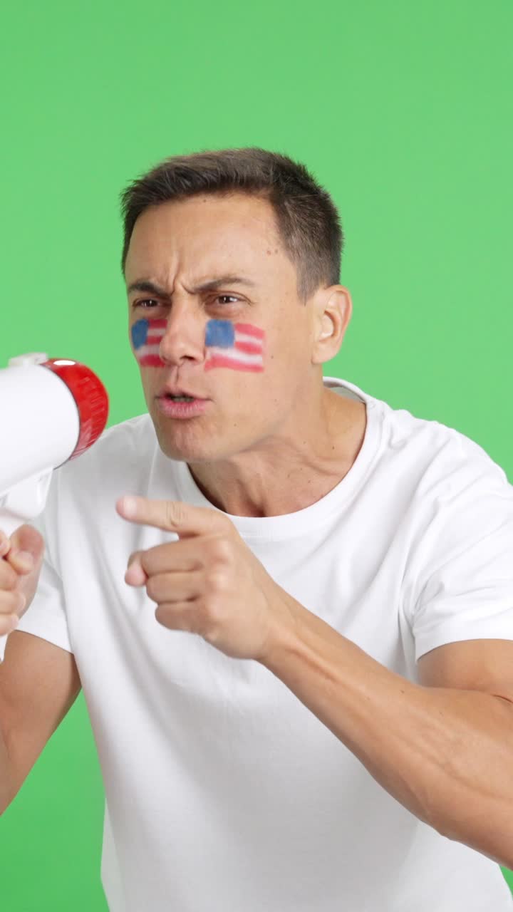 Excited man with United States flag on face using a megaphone