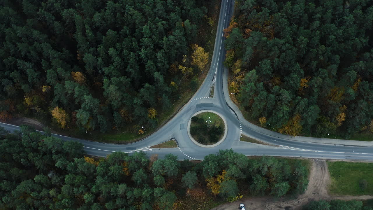 Static aerial view of roundabout in the middle of the woods