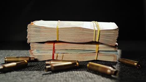 tightly packed euro stacks surrounded by shell casings in dark concept scene
