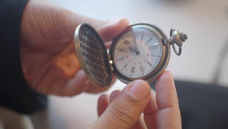 person holding a vintage pocket watch