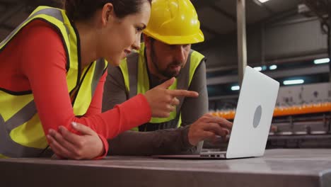 supervisors using laptop near production line