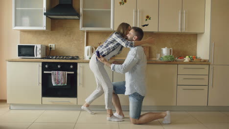 couple's romantic engagement in the kitchen
