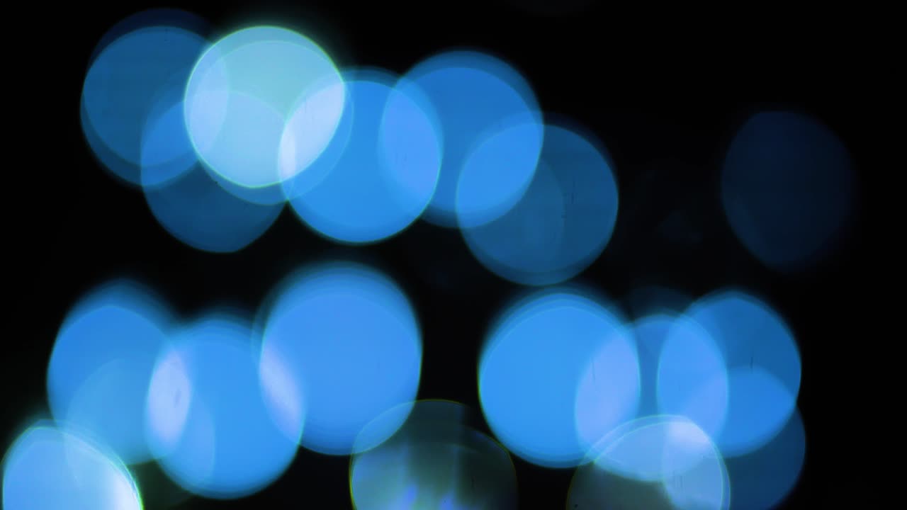 Blå bokeh lys baggrund med flimrende abstrakt bevægelse