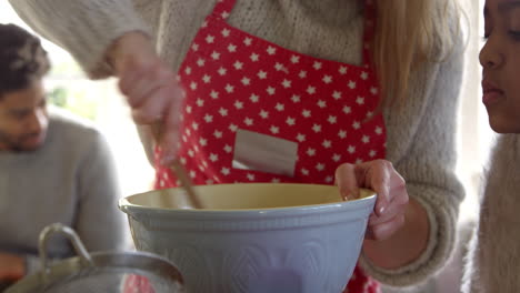 mother and children baking cake at home shot on r3d