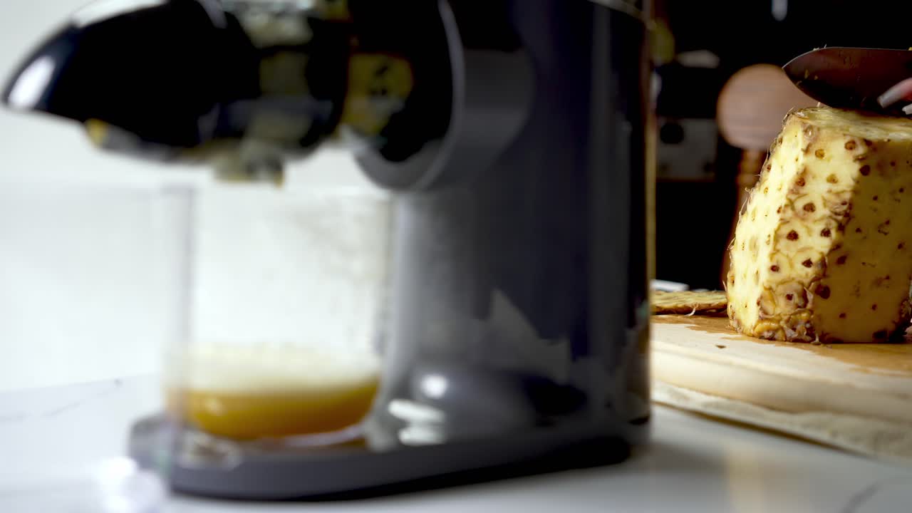Masticating juicer machine, freshly squeezed pineapple, healthy drinks