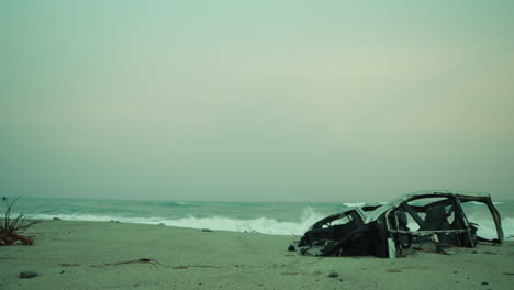 near the ocean a car destroyed by bomb on the beach