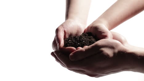 man hands support woman hands with soil