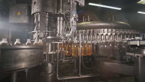 automatic filling machine pours water into plastic pet bottles at modern beverage plant