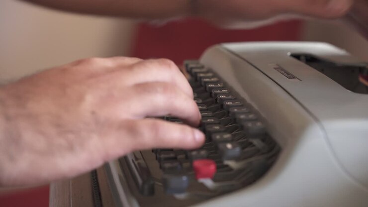 Man's Finger Working And Typing On Mechanical Typewriter In The Workplace