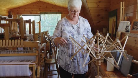 Senior-woman-operating-weaving-machine-4K-4k
