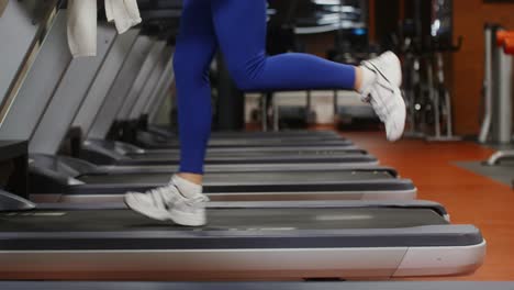 woman running on treadmill in gym