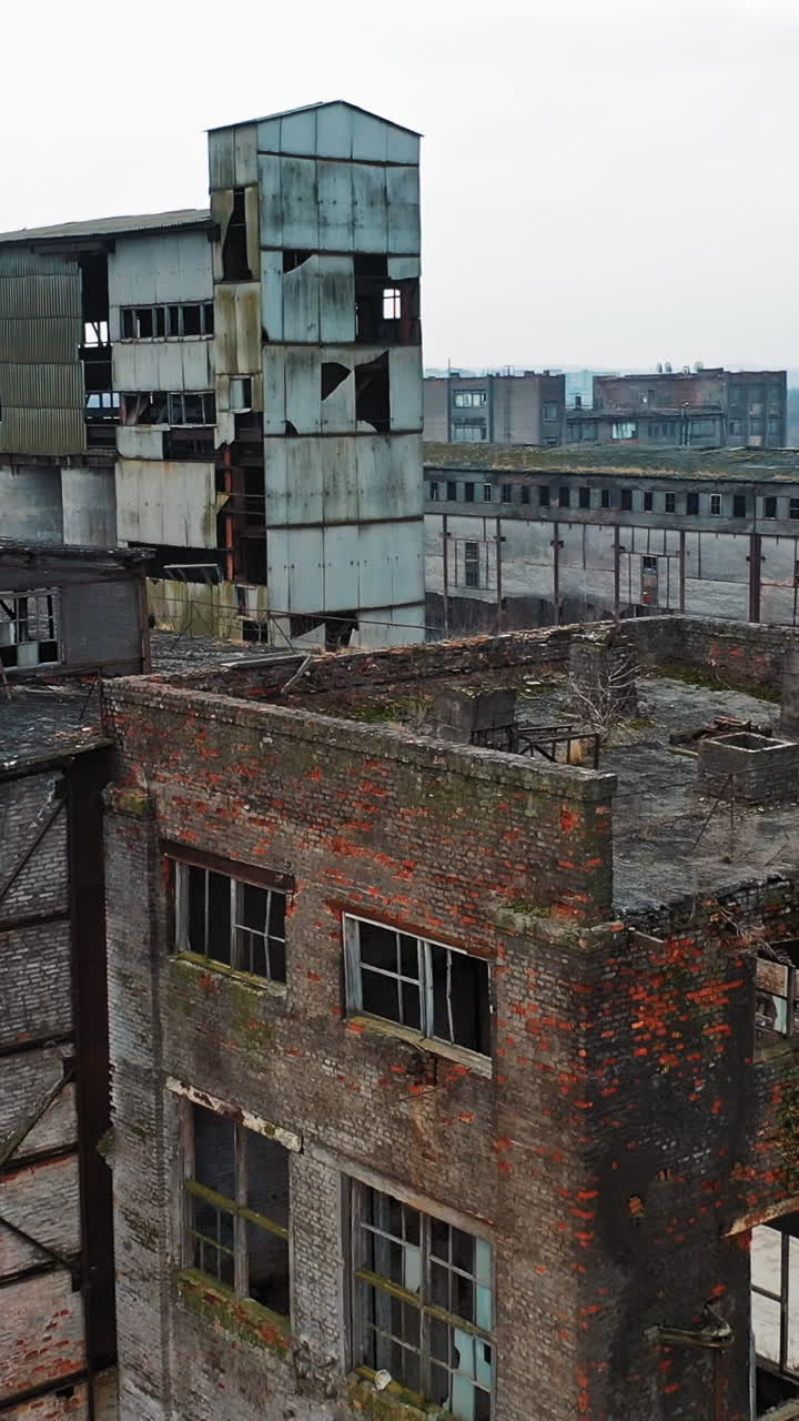 Ruins of an old factory. Old industrial complex. Aerial view Vertical video