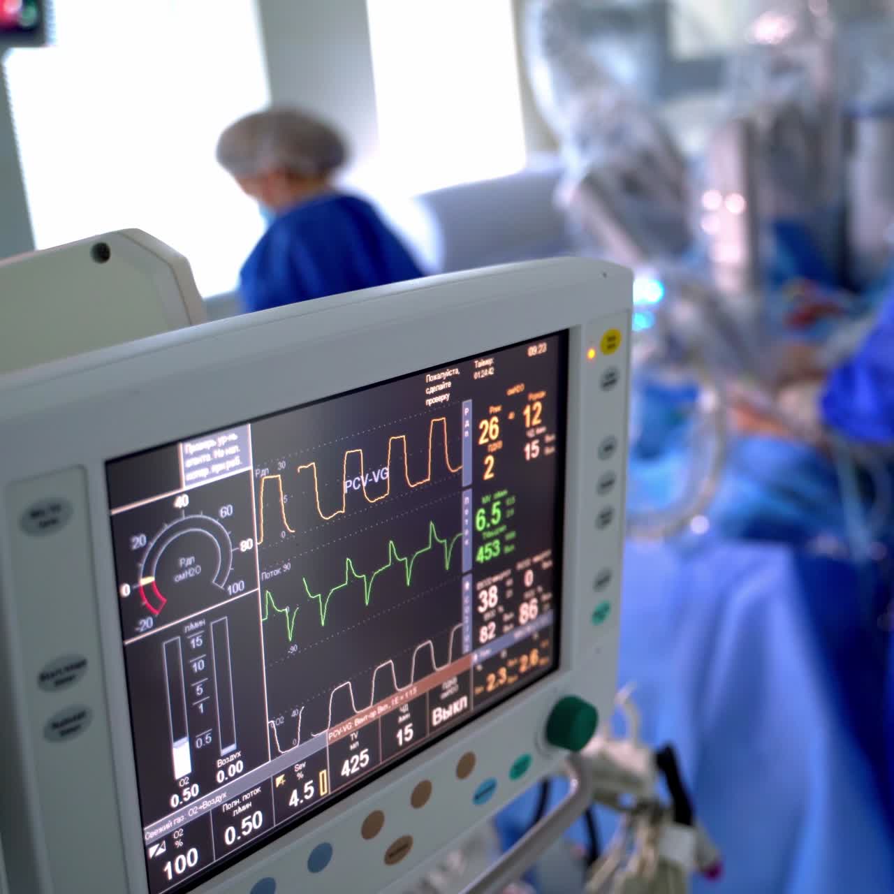 Monitor shows the patient's condition during surgery. Modern medical equipment on the blurred operating process in clinic.