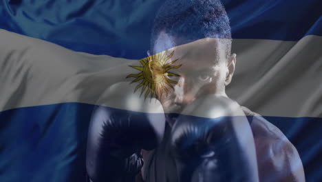 animation of flag of argentina over african american male boxer