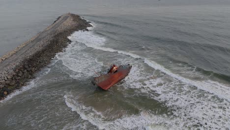 a wrecked rusty old ship washed ashore on a beach filmed in slow motion in lagos, nigeria