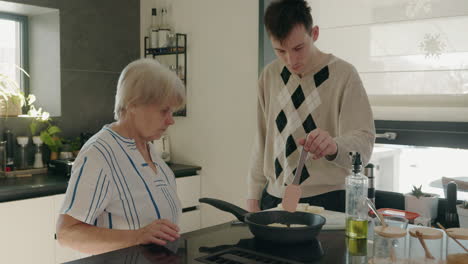 grandmother and grandson cooking together