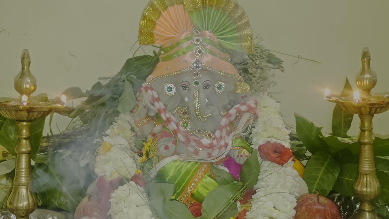 Decorated Ganesh Idol with light Lamps and smoke. closeup shot, internal shot, 4k