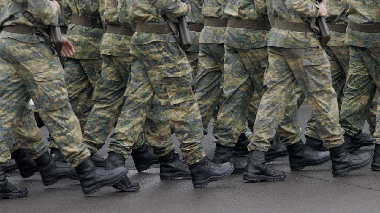 Soldiers marching in camouflage uniforms