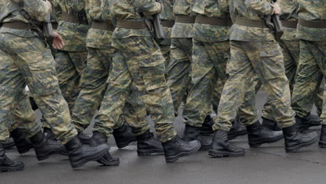 soldiers marching in camouflage uniforms
