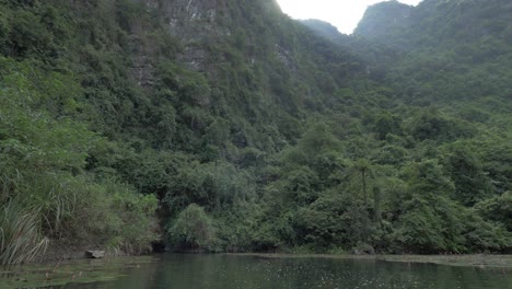 close approach to mountain and cave by boat
