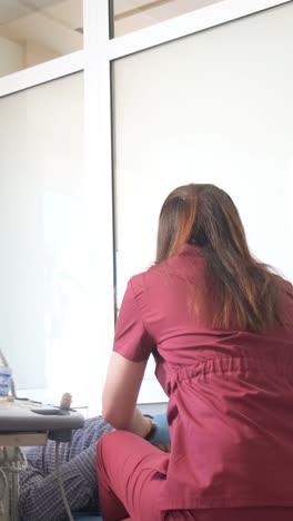vertical video of a female doctor performing an ultrasound. examination of internal organs is a step towards health. professional diagnostics – reliable control. high quality 4k footage