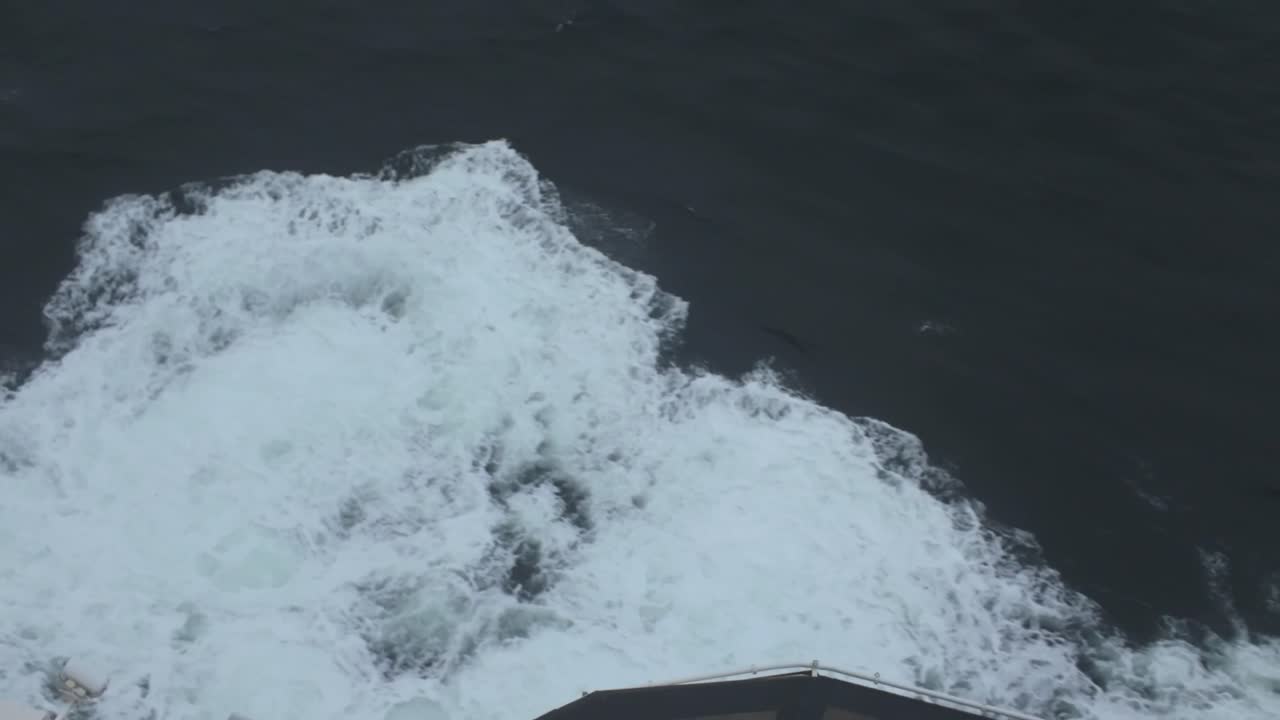 Gimbal close-up shot of the wake and spray from a moving ship on the open ocean in the Pacific Northwest. 4K at 60 FPS Slow Motion