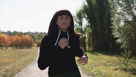 mujer corriendo en el parque de otoño