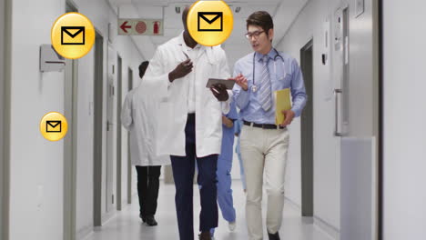 animation of media icons over diverse doctors walking and talking in hospital