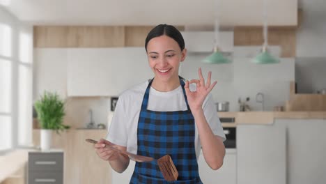 happy indian housewife tasting good food