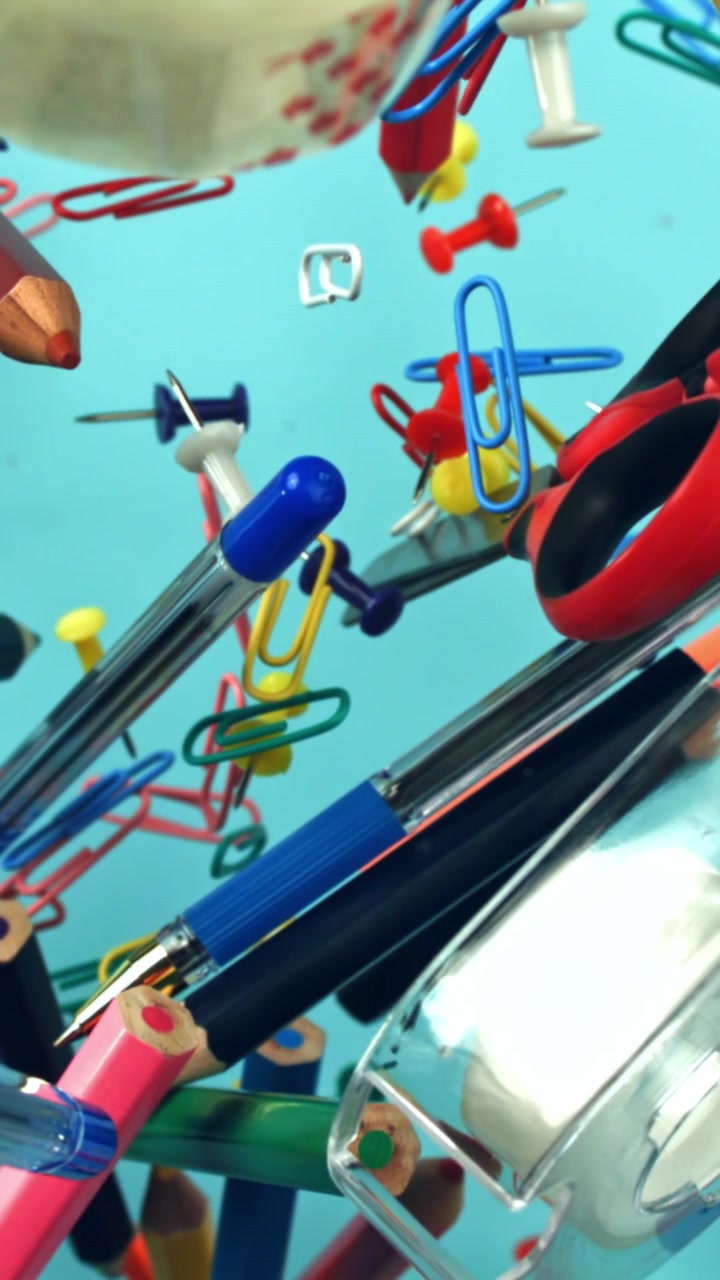 Colorful Office and School Supplies Floating on Blue Background