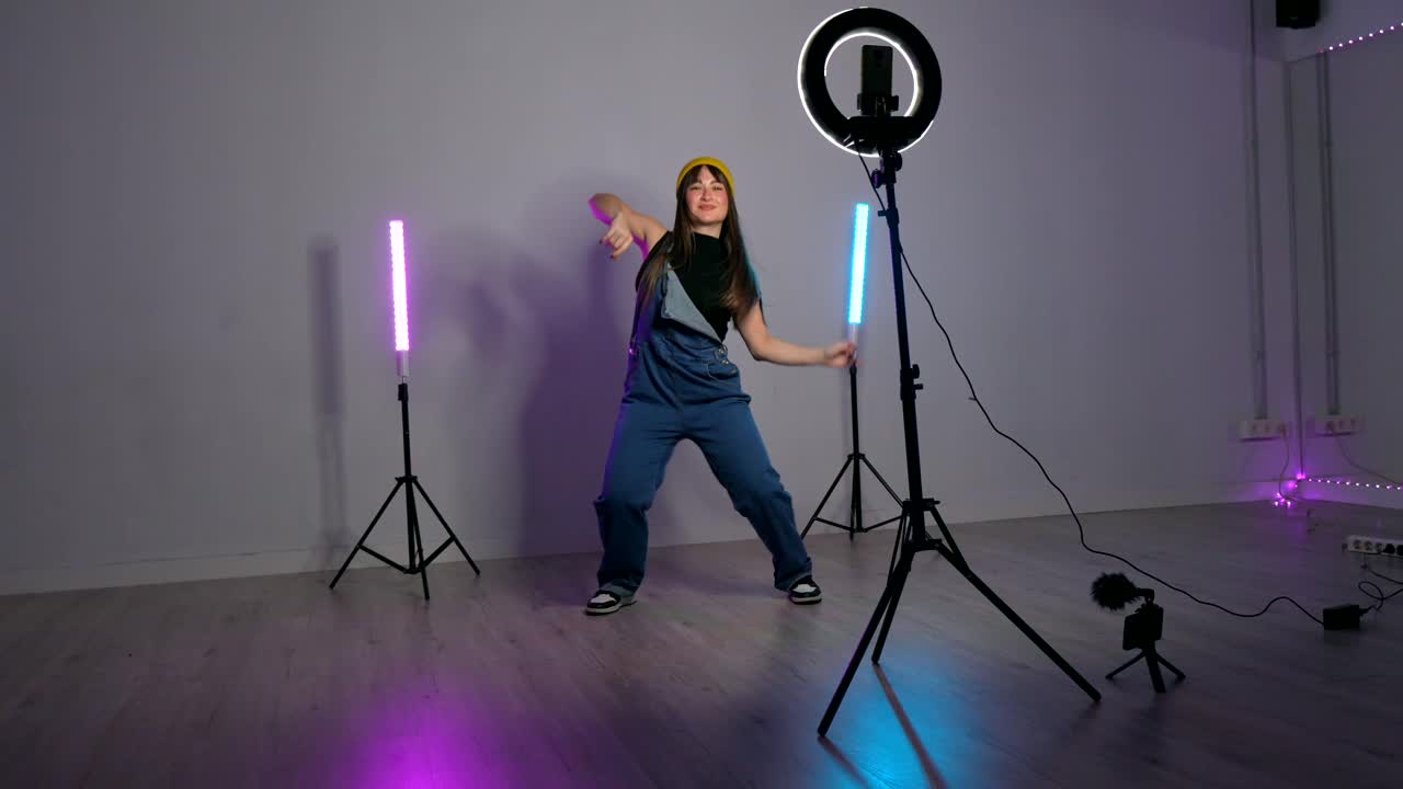 Woman Dancing in Studio with Ring Light and LED Tube Lights