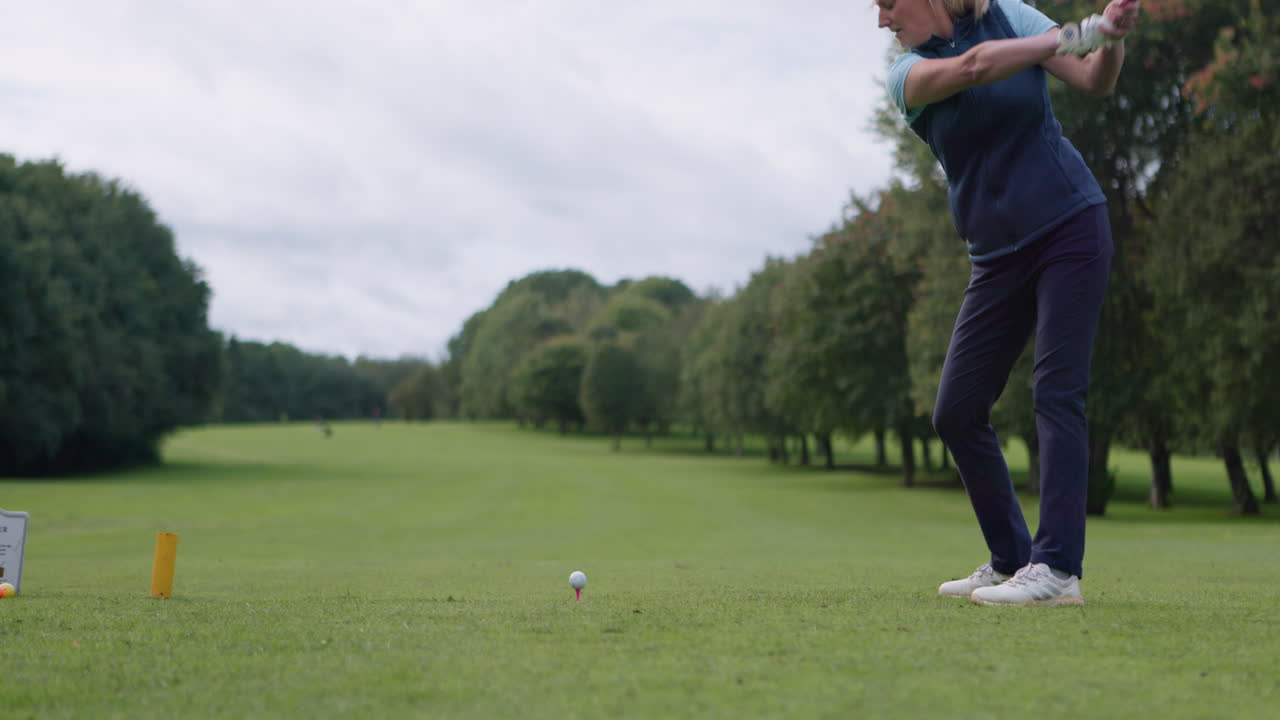 Woman golfing on a golf course