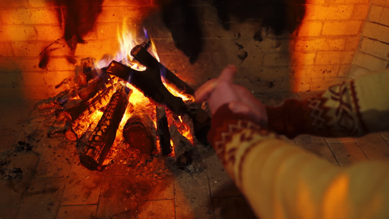 Hands of the man closeup. Male is warming hands near the bonfire at the twilight's inside. Cold season concept.