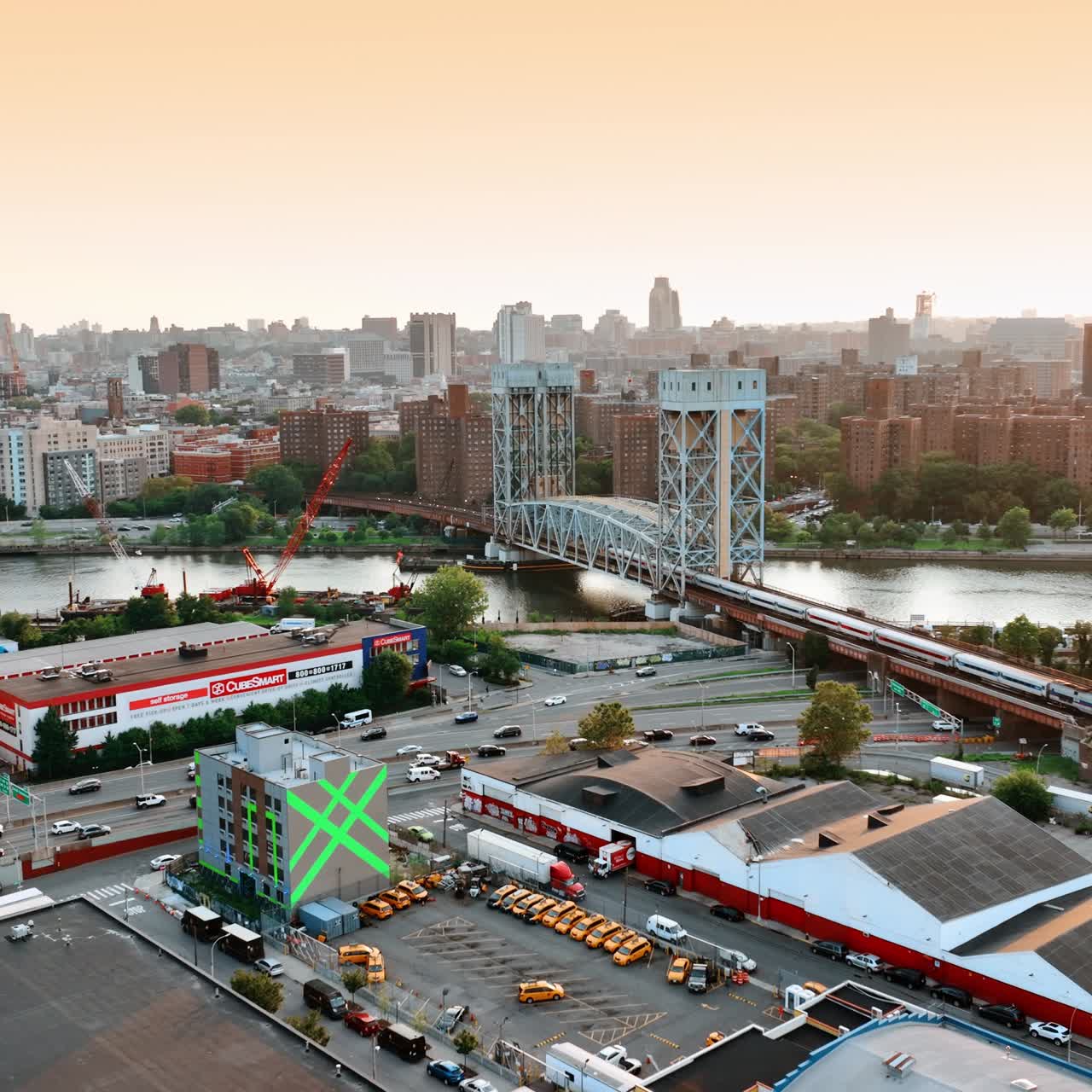 Cityscape of daytime New York with the Harlem River Lift Bridge. Train goes by the bridge