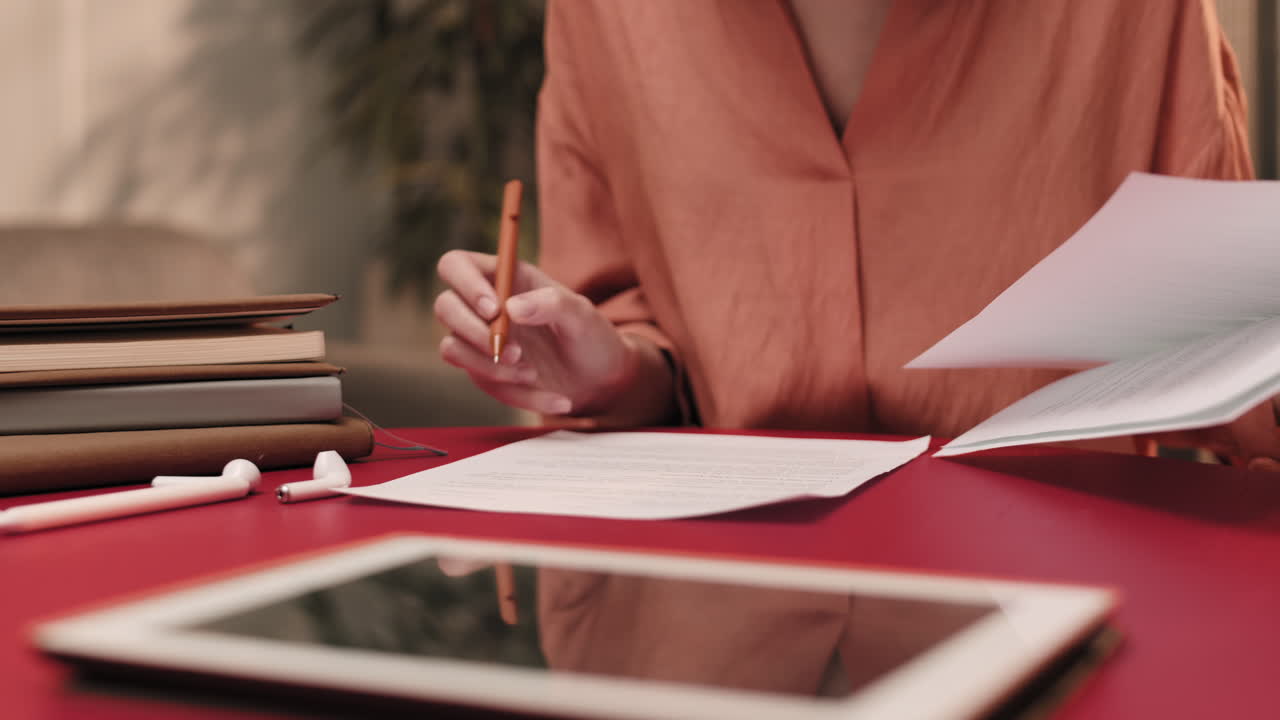 Unrecognizable Person Proofreading Papers