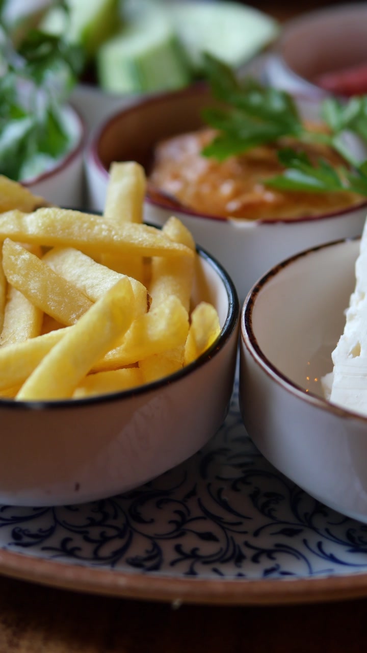 Close-up Panning Shot of a Delicious Breakfast Spread with Cheese and French Fries