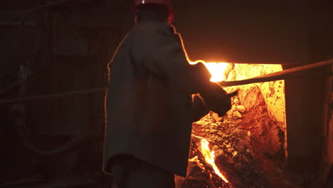 metal worker operating a furnace