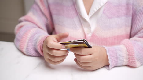 woman's hand holding debit card for secure online shopping