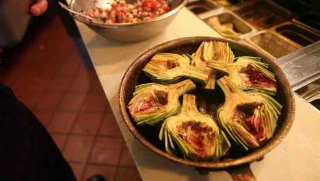 an entree of artichokes is presented ion a bowl