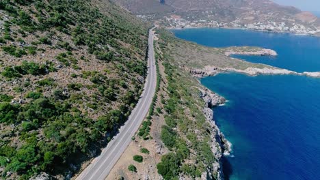 a shot from a drone of a road on the coast of the greek island of crete