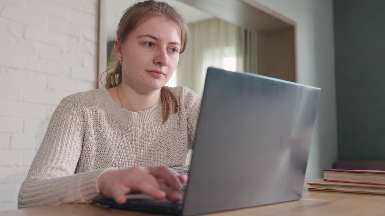 Woman working on laptop at home