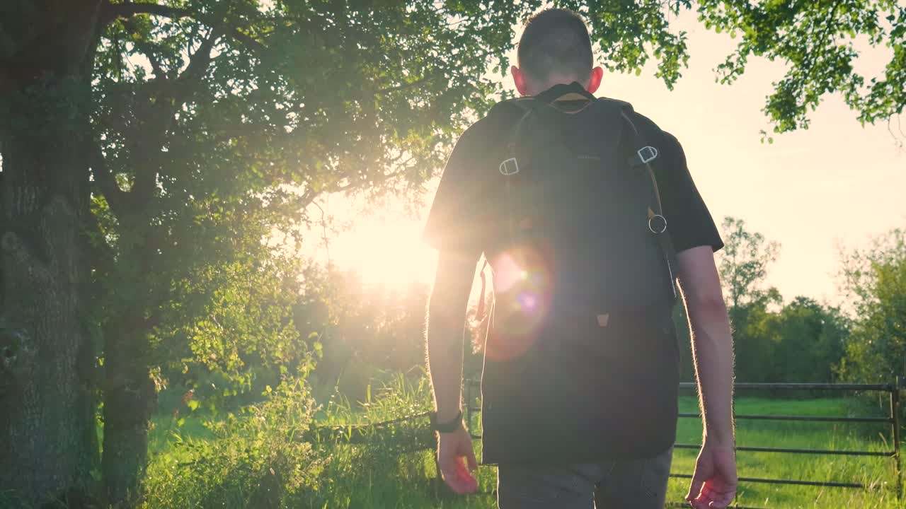Man Hiking in a Sunny Field