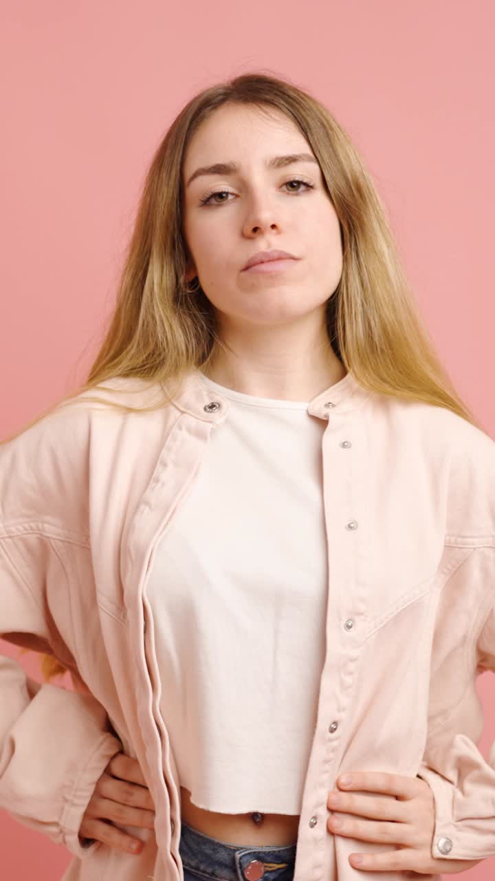 Young woman posing on pink background