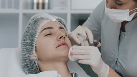 woman receiving lip filler injection