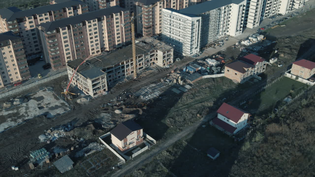 Point of interest quick shot of a building being under construction and some tower cranes 4K