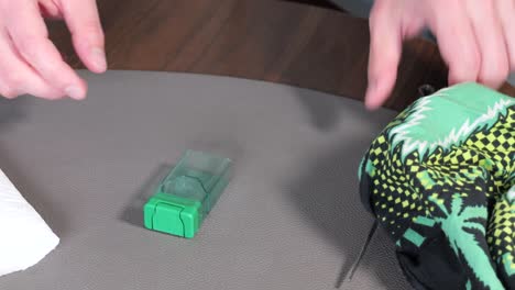 man prepares cannabis marijuana seeds from the box with tweezers to grow a cannabis plant at apartment